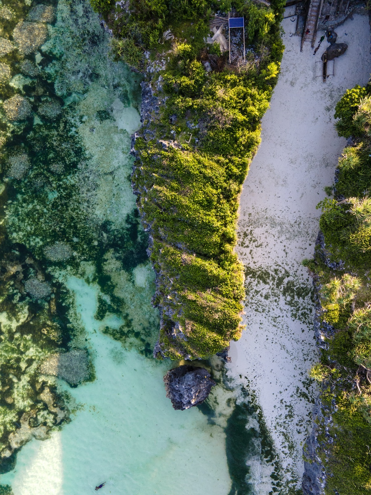 Aerial view of a tropical resort with palm trees and white sand beach on Zanzibar's south coast near Kizimkazi